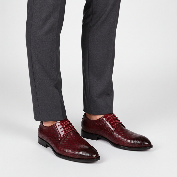 Close-up of men's black leather oxford shoes, highlighting the intricate lacing and classic design