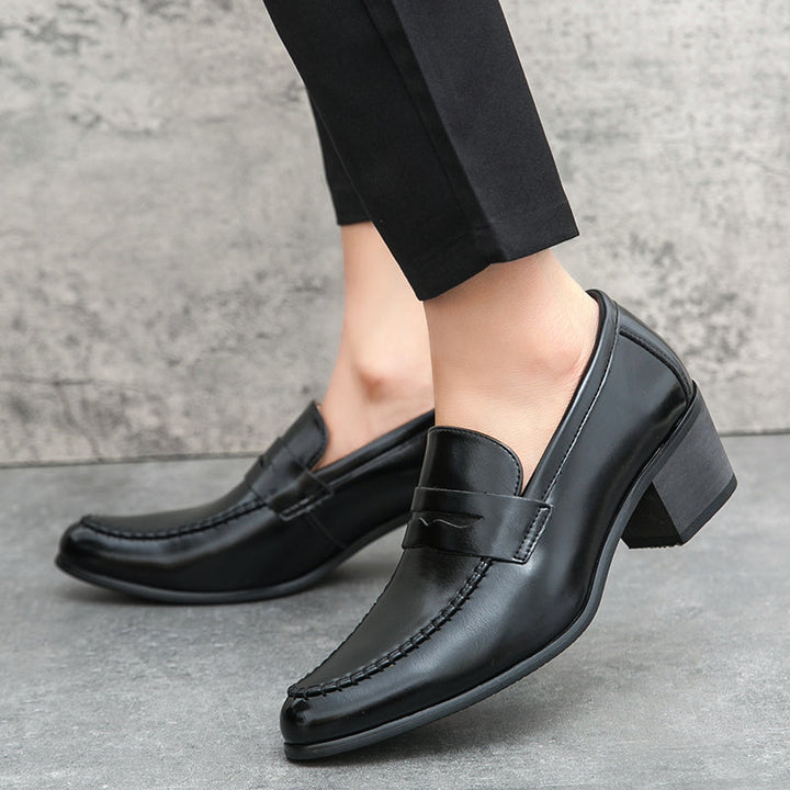Side view of men's sleek black slip-on loafers, showcasing elegant design and comfortable fit.