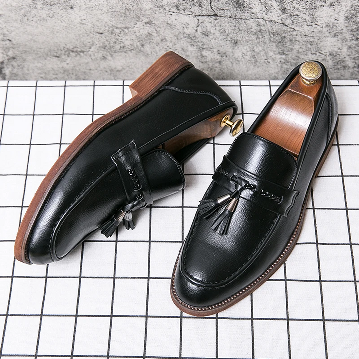 Classic men's tassel loafers in deep leather, offering polished sophistication & all-day wear.