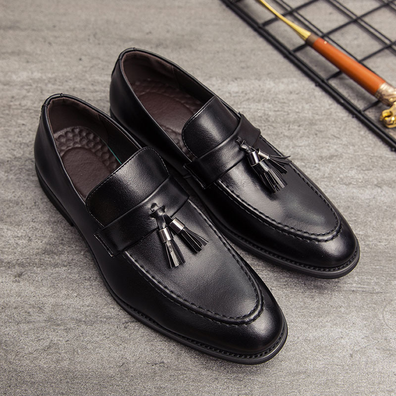 Detailed shot of men's premium leather tassel loafers, highlighting slip-on convenience.