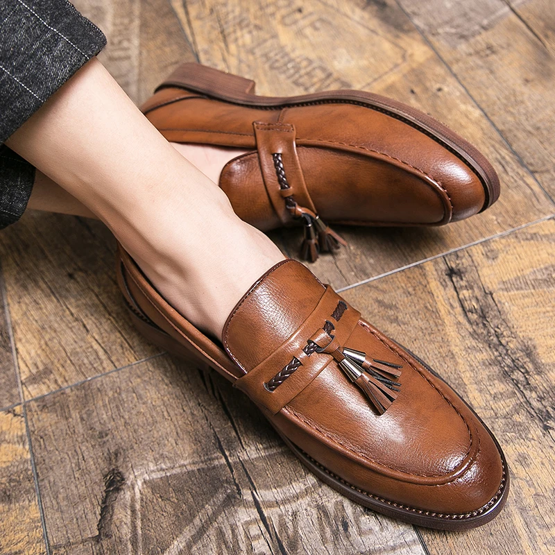 Classic men's loafers with decorative tassels, a versatile choice for business or smart casual.