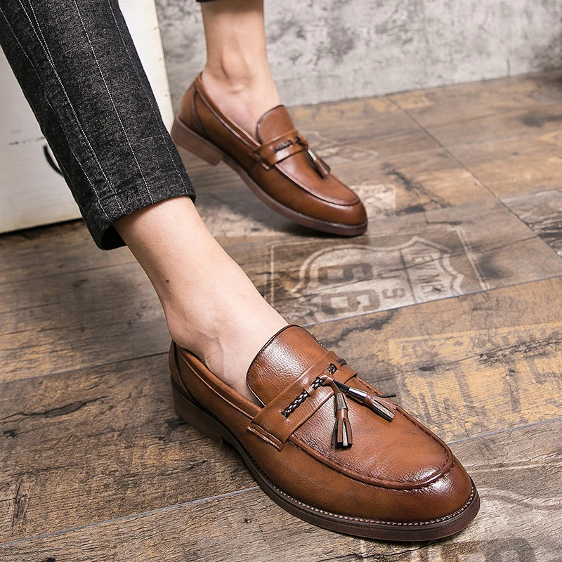 Polished black leather men's tassel loafers, sophisticated footwear for business & elegant style.