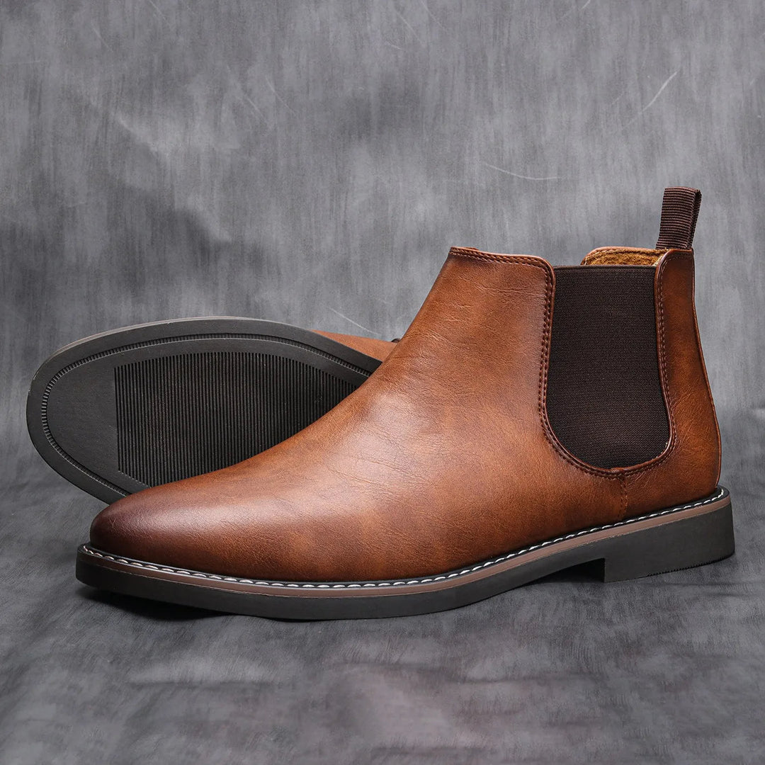 Stylish black leather men's Chelsea boots, versatile for dress or casual, easy slip-on comfort.