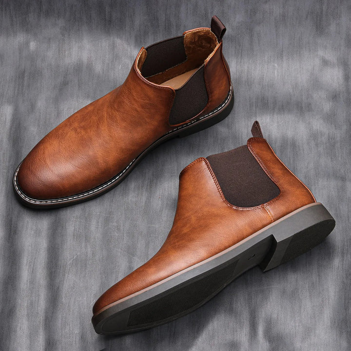 Rich brown leather men's Chelsea boots, sleek profile, ideal fall & winter fashion for men.