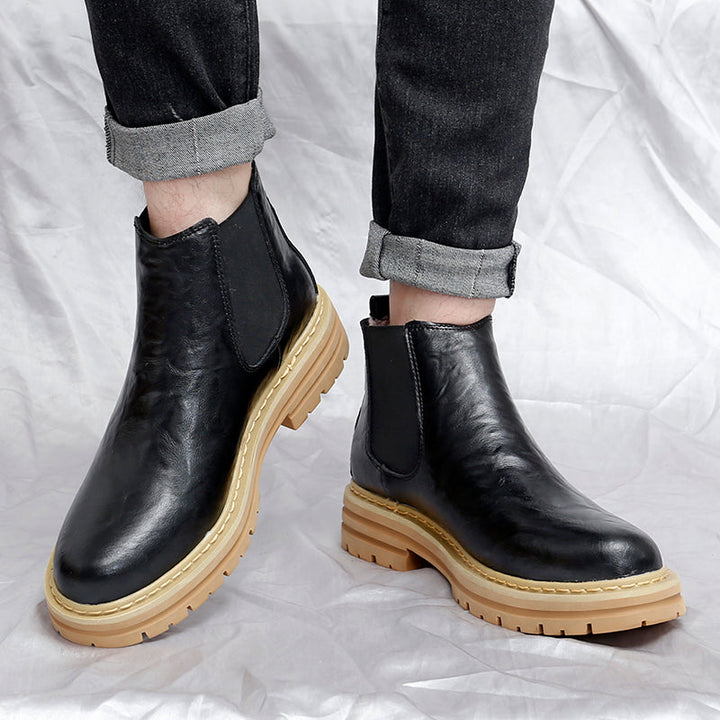 Men's casual Chelsea boots paired with jeans, showcasing comfortable, classic ankle boot fashion footwear.