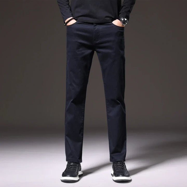 Versatile men's classic cotton chino trousers in khaki, brown, & navy; comfortable for casual outfits.