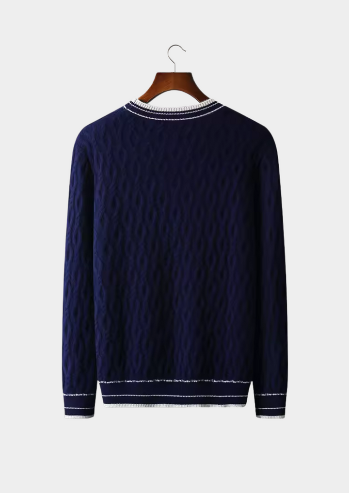 Close-up of a men's crew neck sweater showcasing its cable knit texture and subtle striped trim. High-quality knitwear.
