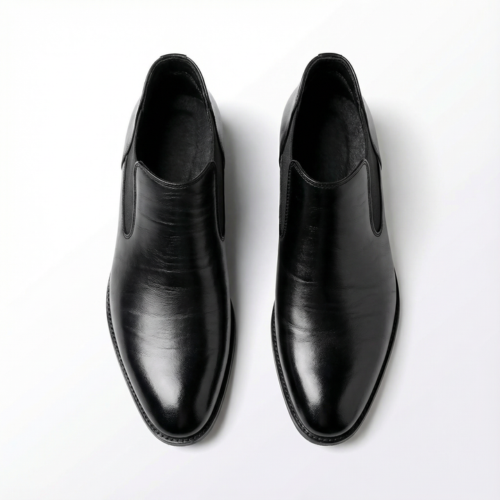 Men's durable black leather Chelsea boots, shown paired with smart casual attire for a complete look.