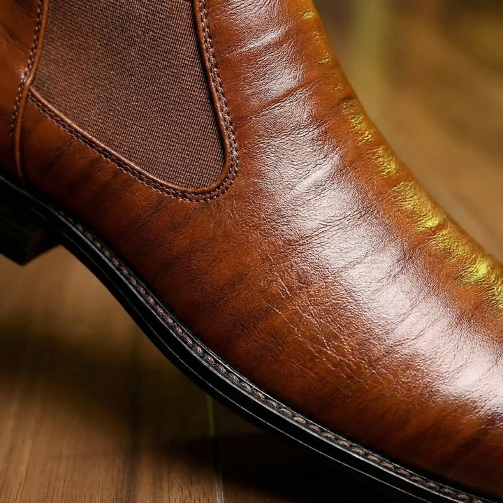 Classic men's dark brown leather Chelsea boots, featuring elastic sides for comfortable slip-on wear.