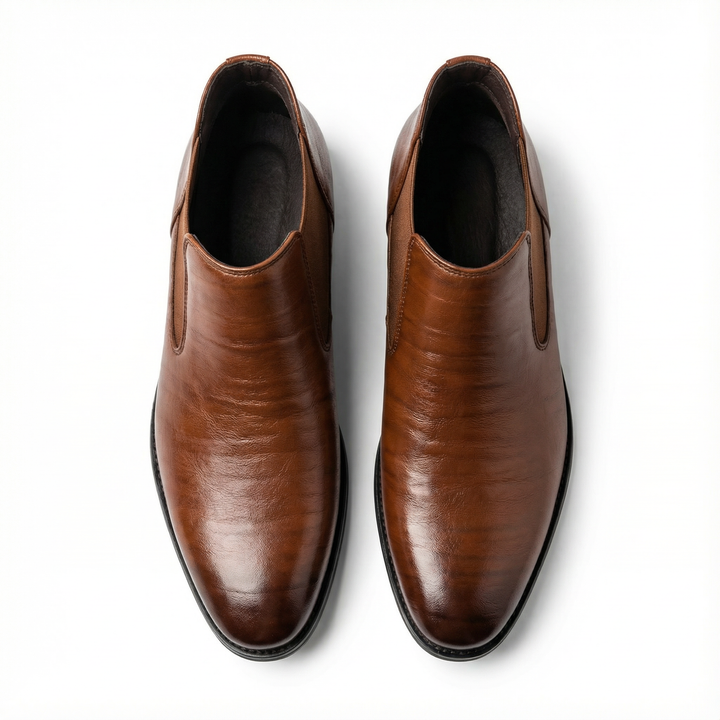 Detail shot: Textured dark brown leather on men's Chelsea boots, highlighting craftsmanship.