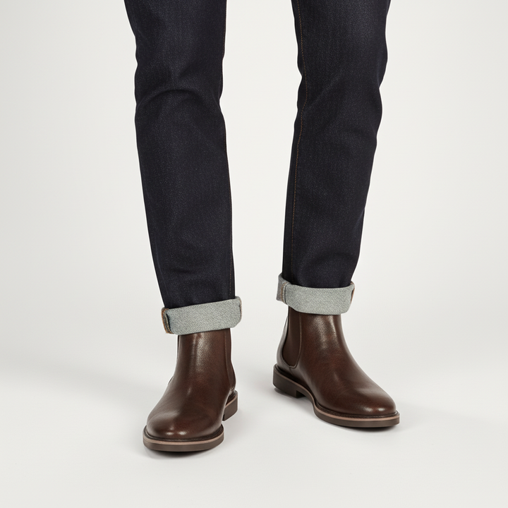 Close-up of men's black leather Chelsea boot with elastic side panel and pull tab
