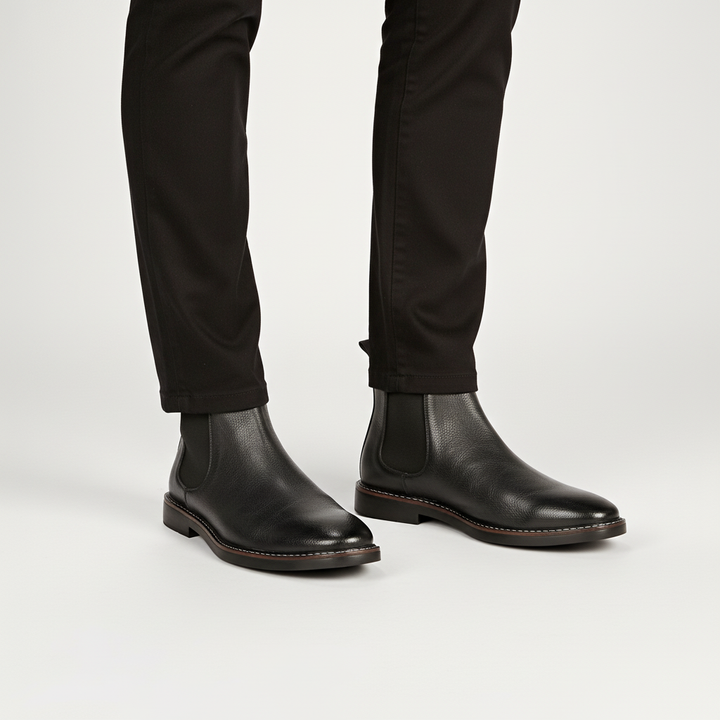 Detailed shot of the elastic gusset on men's classic black Chelsea boots, durable leather