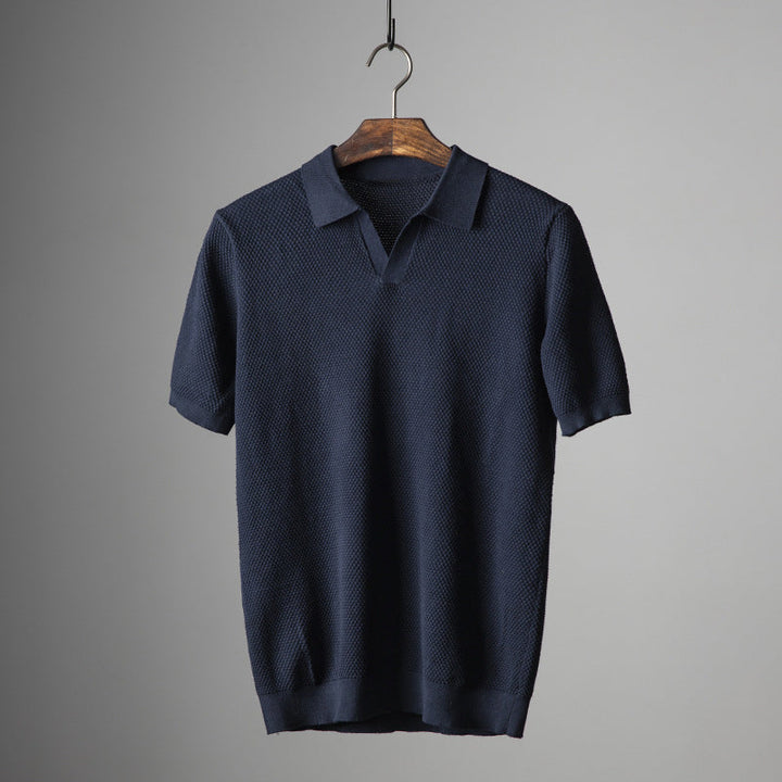Dark blue men's short sleeve polo shirt, classic fit for casual wear, comfort, and summer style.