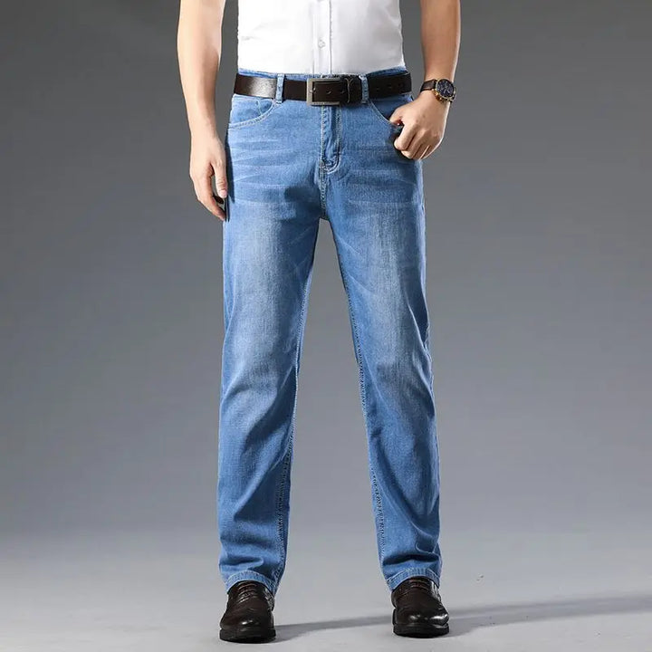 Close-up of comfortable cotton blend stretch denim fabric of men's blue classic fit jeans.