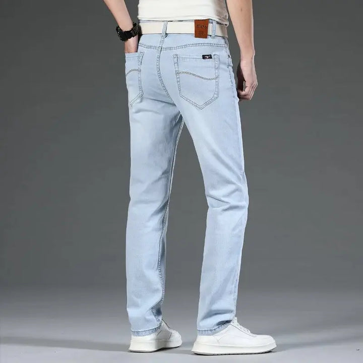 Back view of men's classic blue stretch denim jeans, featuring pocket design and versatile everyday style.
