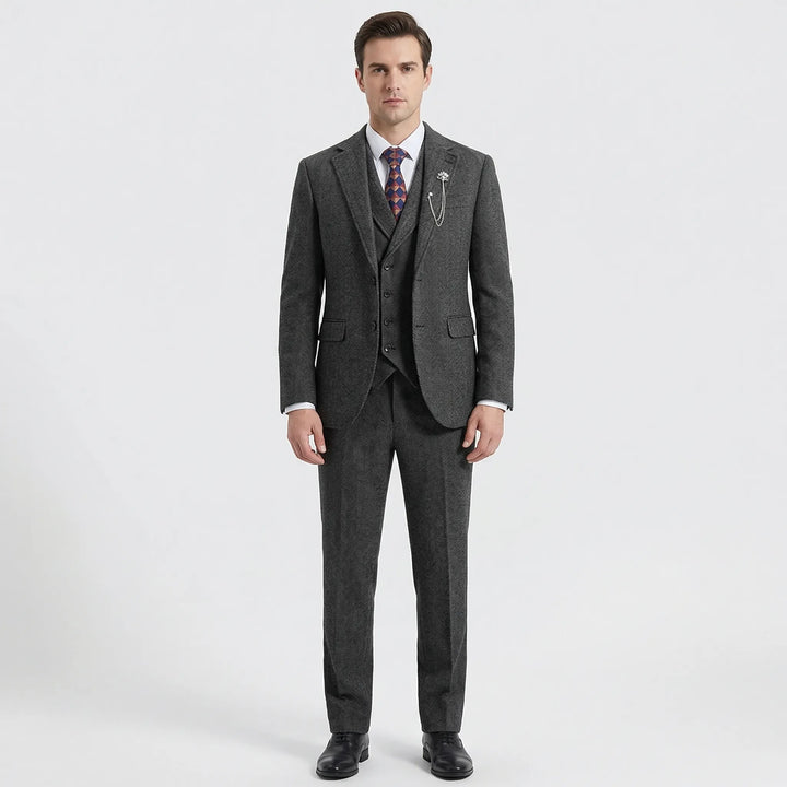 Close-up of men's herringbone pattern 3-piece suit fabric, showcasing classic texture.