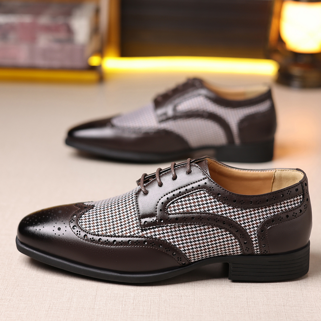 Stylish men's formal footwear: houndstooth pattern, wingtip brogue design, perfect for any event.