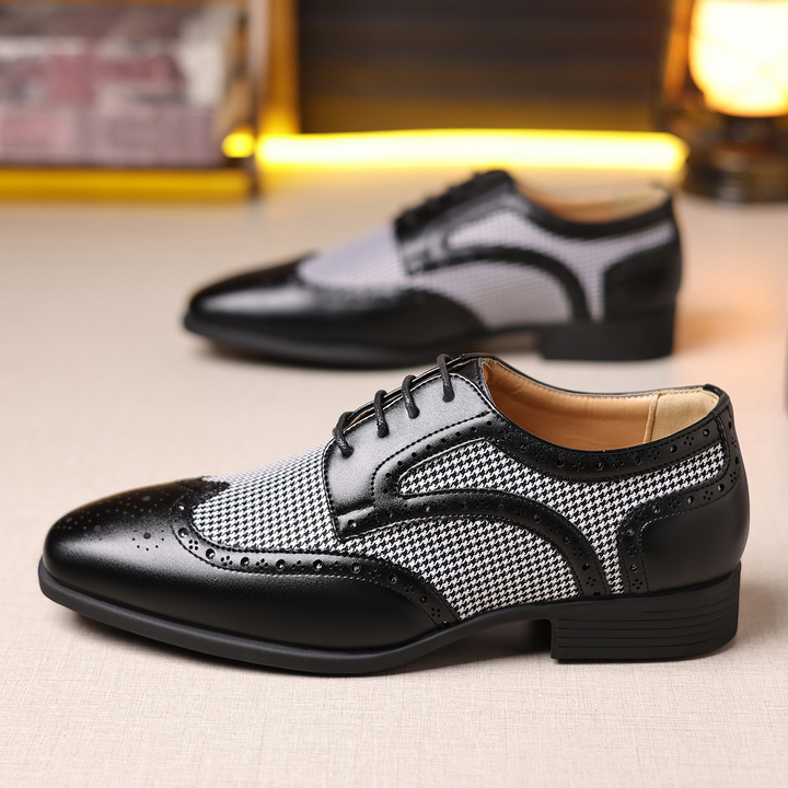 Close-up of men's houndstooth oxford shoes, featuring elegant wingtip and brogue detailing.