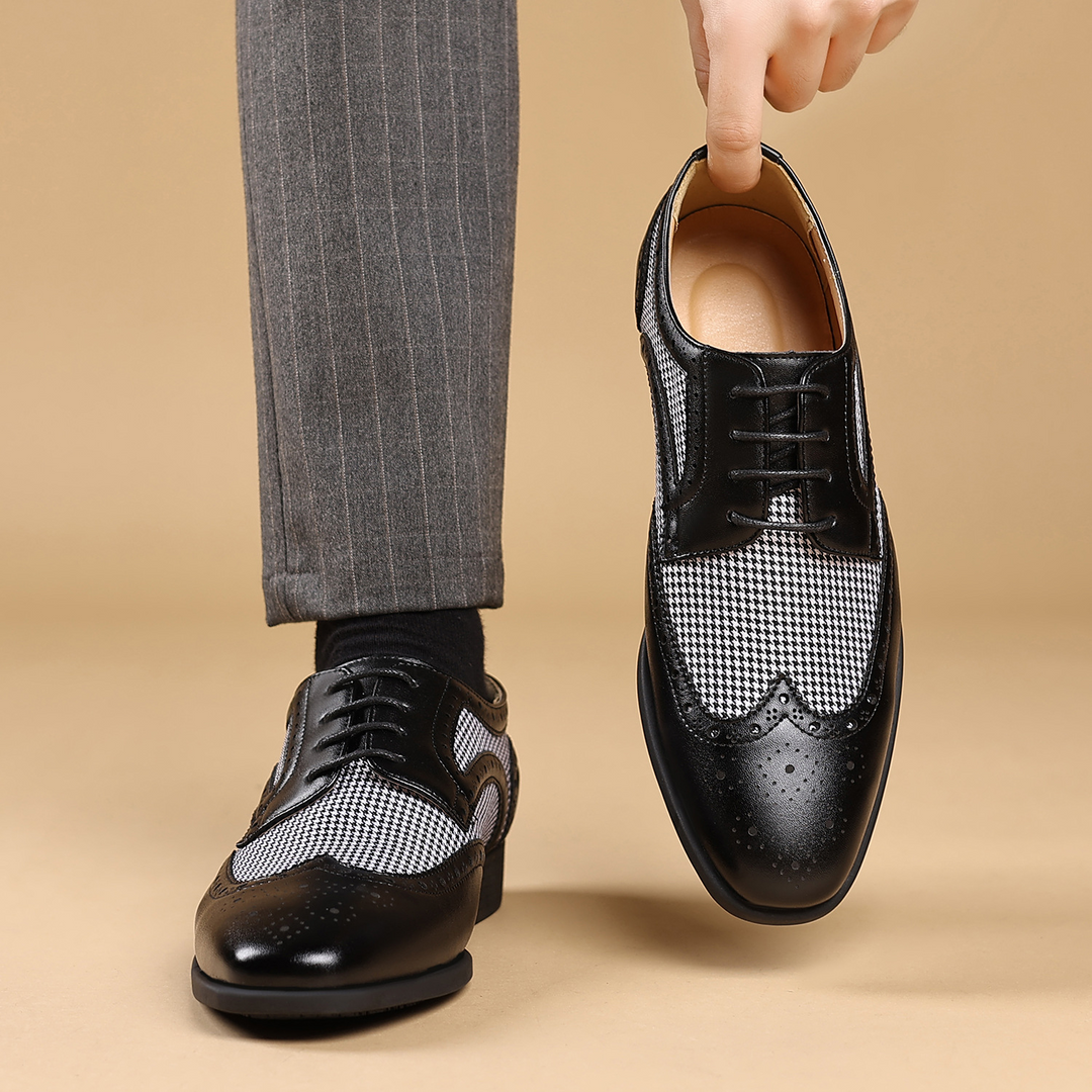 Side view of classic men's dress shoes, showcasing the sophisticated houndstooth pattern & wingtip design.