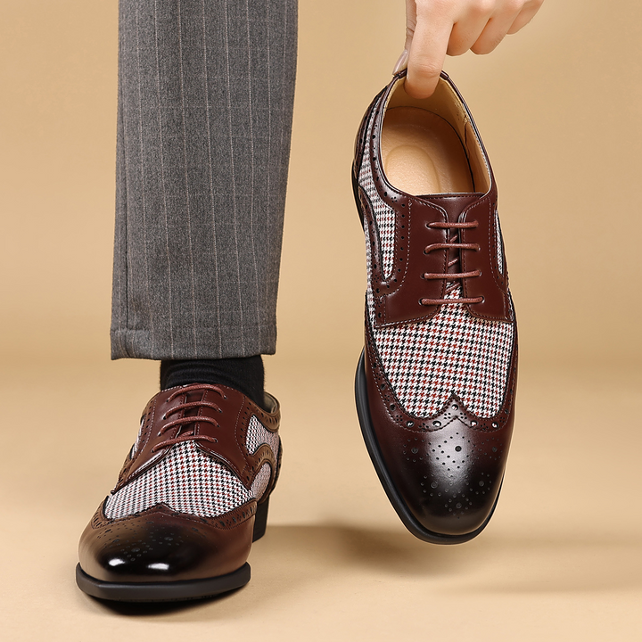 Detail shot of the houndstooth fabric on men's stylish dress shoes. Premium wingtip design.