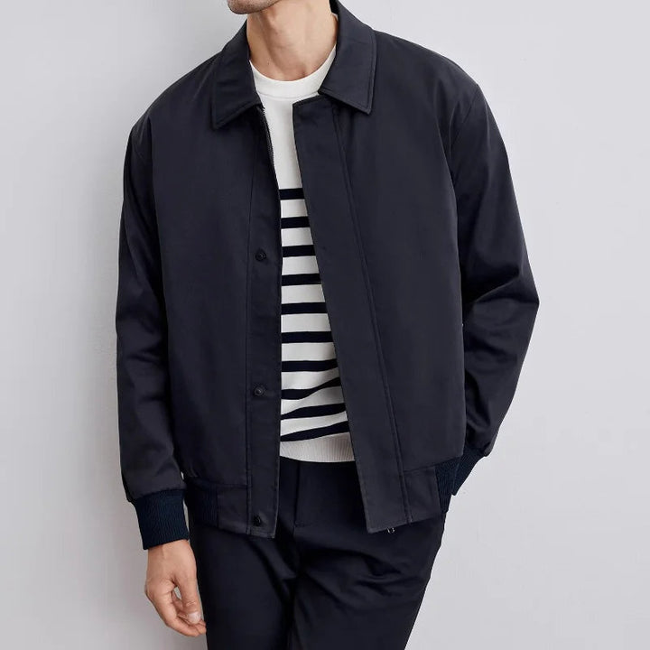 Man wearing a stylish men's Harrington jacket in black for a casual, comfortable all-season look.