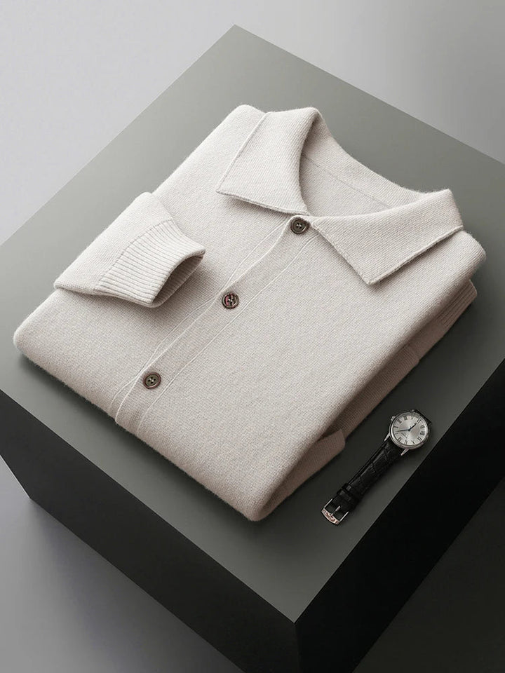 Close-up of a men's charcoal gray knit cardigan, highlighting soft texture, polo collar, and button-front details.