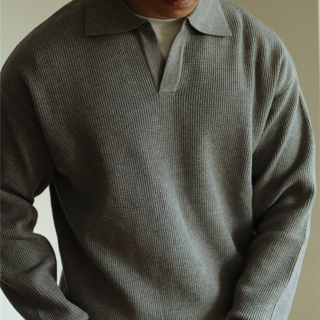 Detail shot: Classic fit men's knit polo top with two-button placket and collar. Everyday comfort.