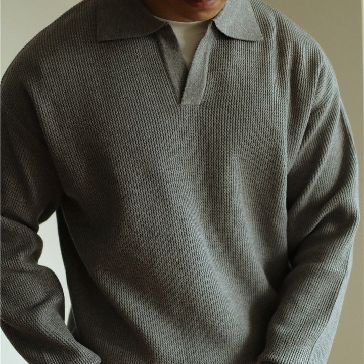 Detail shot: Classic fit men's knit polo top with two-button placket and collar. Everyday comfort.