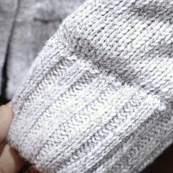 Man wearing a classic knitted hooded gilet. Versatile sleeveless jacket, ideal for casual men's fashion layering.
