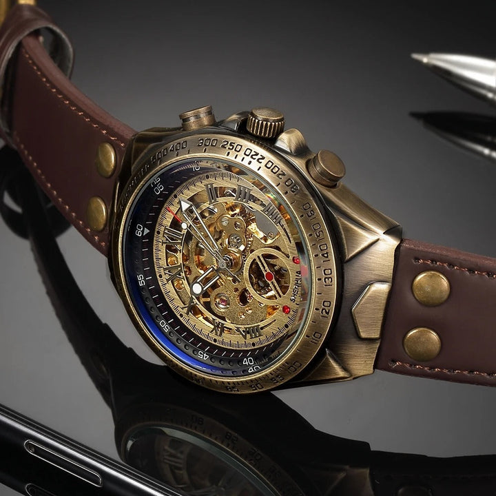 Antique gold men's skeleton watch with brown leather strap, showcasing intricate hand-wound movement.