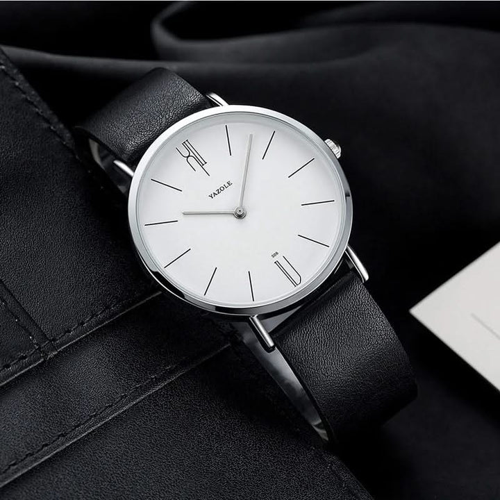 Close-up of a men's classic watch showcasing its premium leather band and minimalist, easy-to-read dial.
