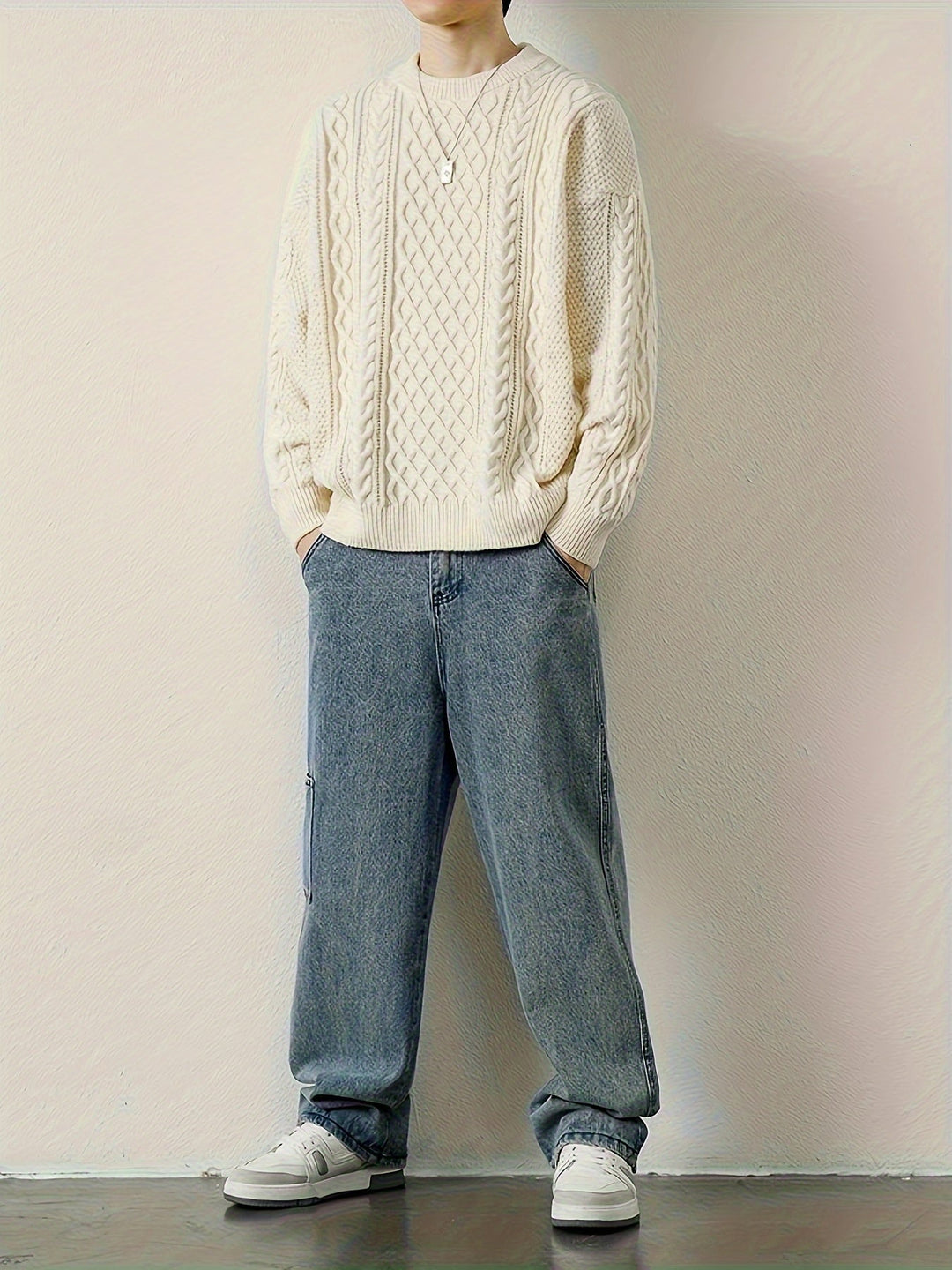 Soft men's cable knit jumper in light grey, a comfortable choice for casual style.