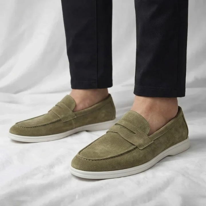 Stylish men's green penny loafers. Comfortable slip-on footwear for smart casual everyday wear.