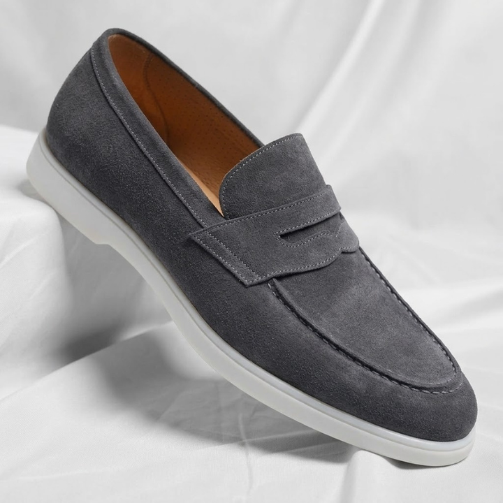 Navy blue men's penny loafers. Smart casual slip-on footwear for comfortable everyday fashion.