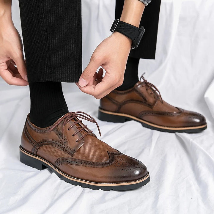 Elegant black polished leather men's brogue formal shoes, ideal for professional attire.