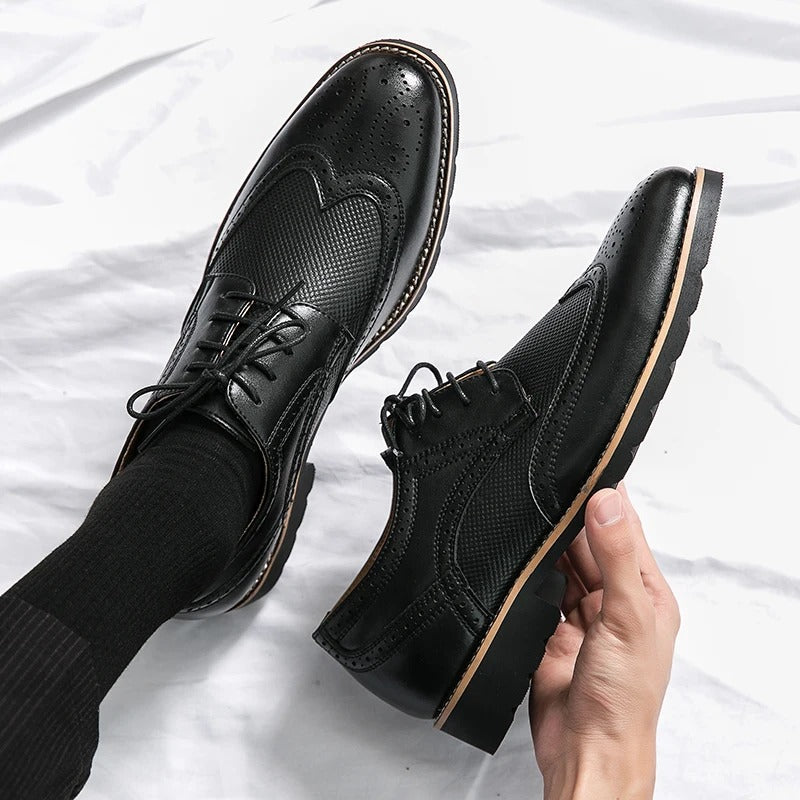 Stylish men's leather brogue dress shoes with a polished finish, classic formal footwear.