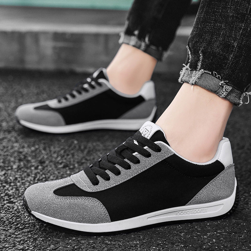 Close-up of premium material on men's retro comfort sneakers, highlighting quality & style.