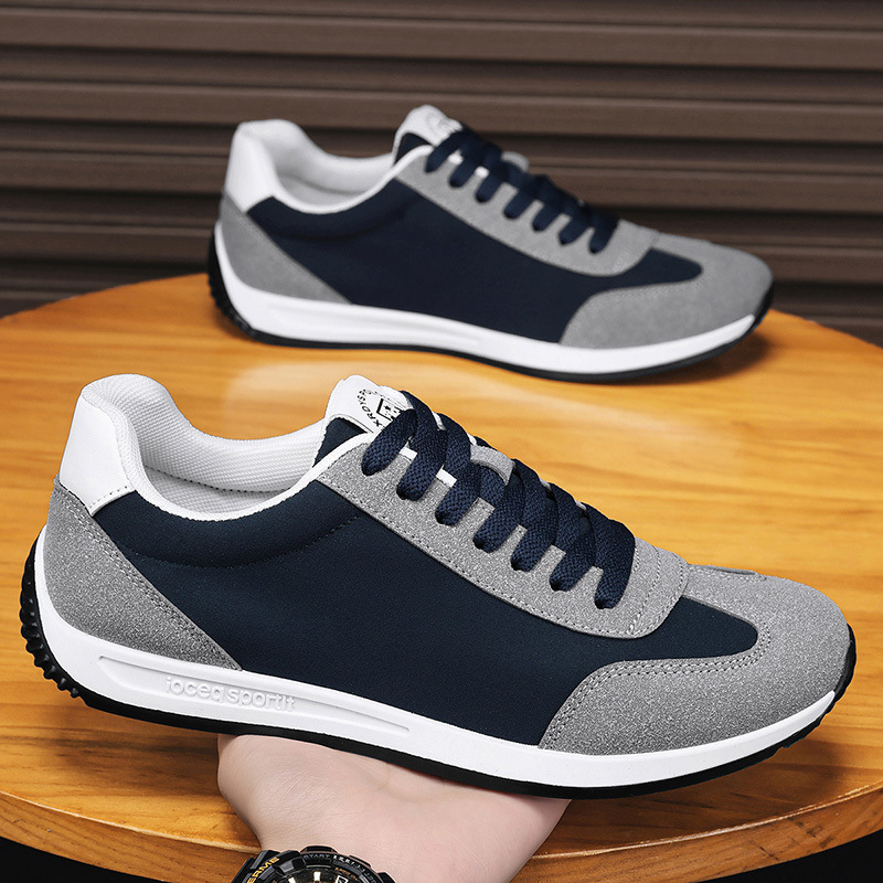 Underside of men's athletic retro sneakers, showing durable traction sole for grip & comfort.