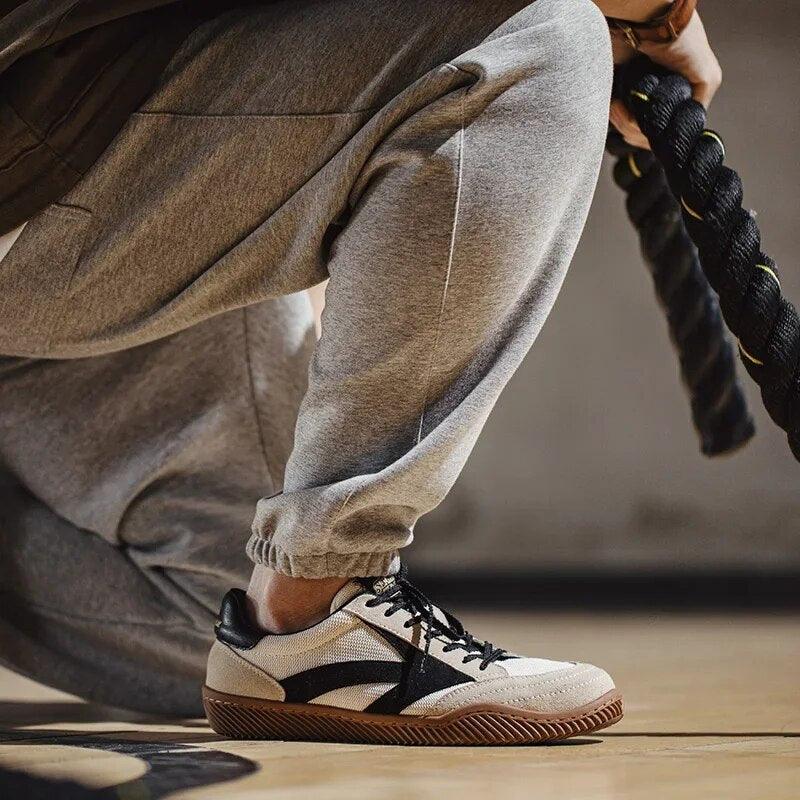 Black men's retro athletic sneakers, featuring classic vintage style & modern all-day comfort.
