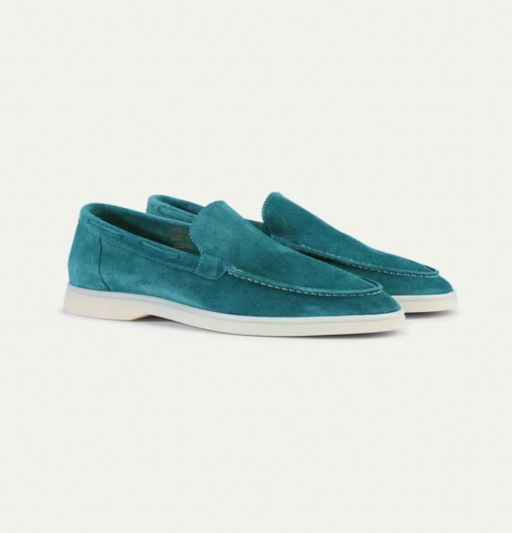 Close-up of the premium leather texture on classic men's slip-on loafers, highlighting quality.
