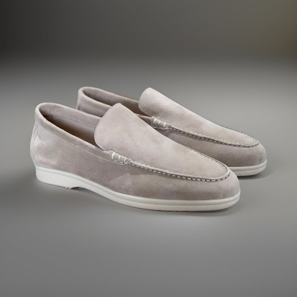 Elegant men's classic slip-on loafers with subtle stitching, suitable for dress or casual outfits.