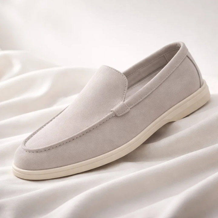 Pair of men's classic slip-on loafers, ready for versatile casual or formal styling. Comfortable footwear.