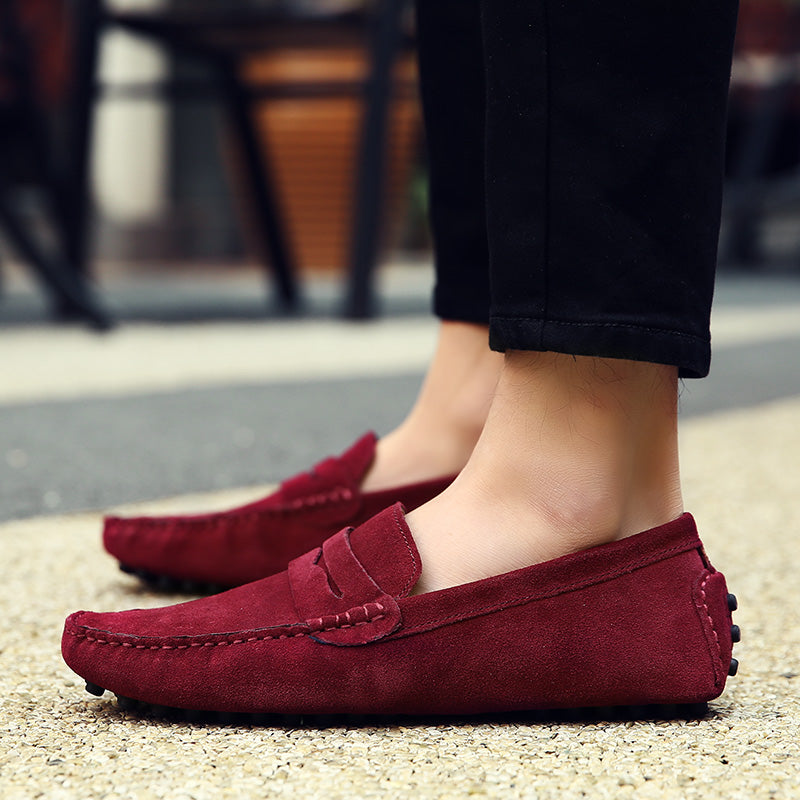 Front view of men's classic slip-on loafers. Stylish toe design, comfortable everyday men's footwear.