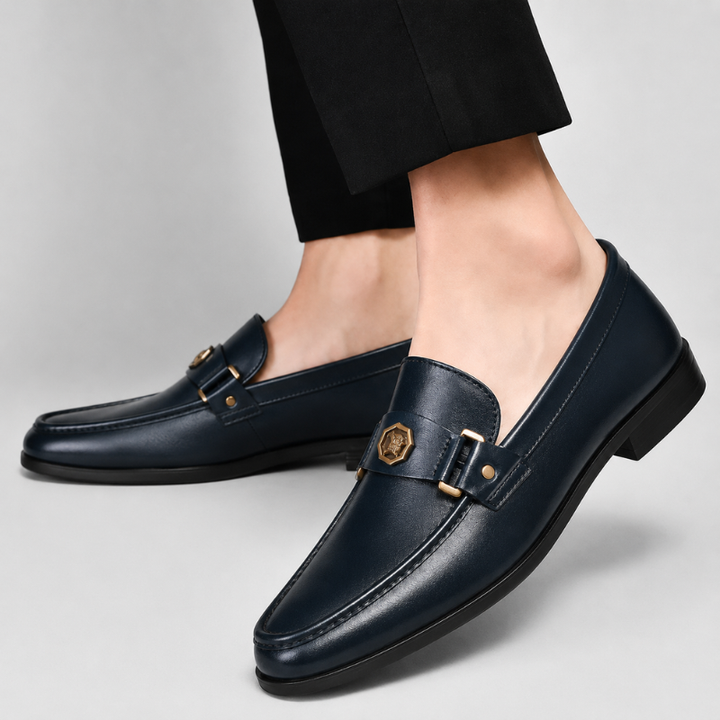 Stylish navy slip-on loafers for men, featuring a polished metal accent and comfortable classic design.