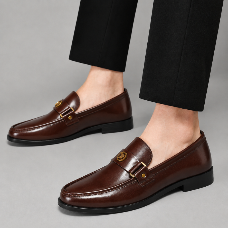 Sleek black men's classic slip-on loafers, designed with a polished metal detail for versatile fashion.