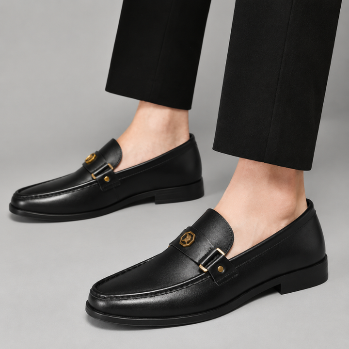 Polished metal detail on men's classic slip-on loafers, combining comfort with sleek, sophisticated style.