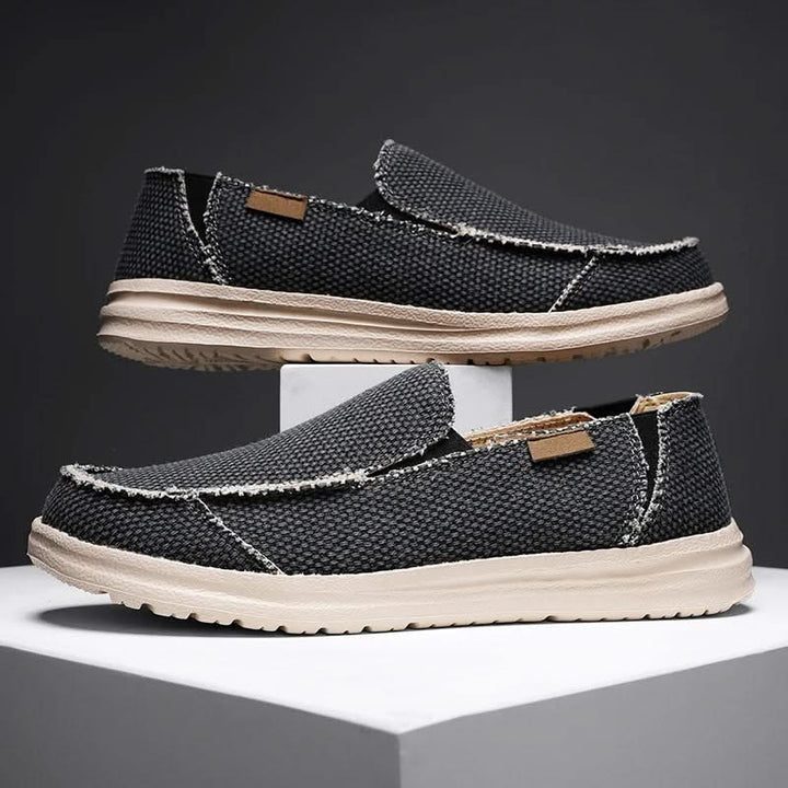 Black men's classic slip-on loafers, comfortable & durable footwear for casual style. Lightweight design.