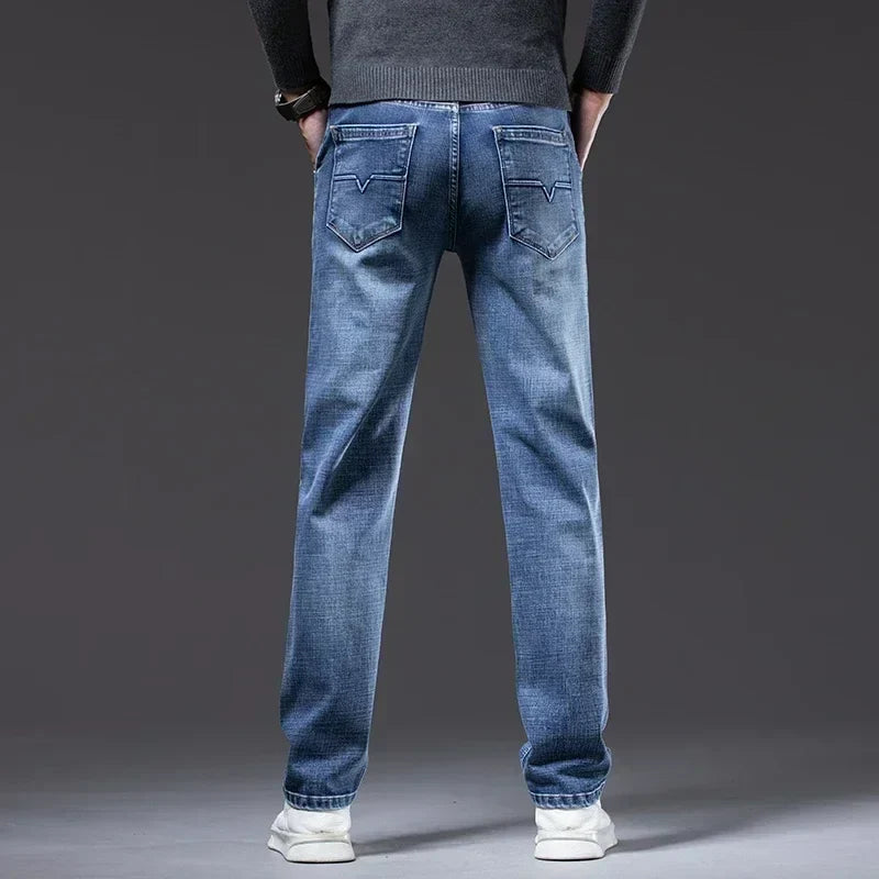 Classic men's blue denim jeans, straight fit. Cotton blend stretch denim, perfect for everyday wear.