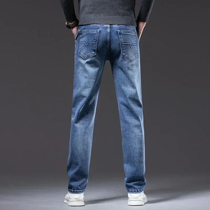 Classic men's blue denim jeans, straight fit. Cotton blend stretch denim, perfect for everyday wear.