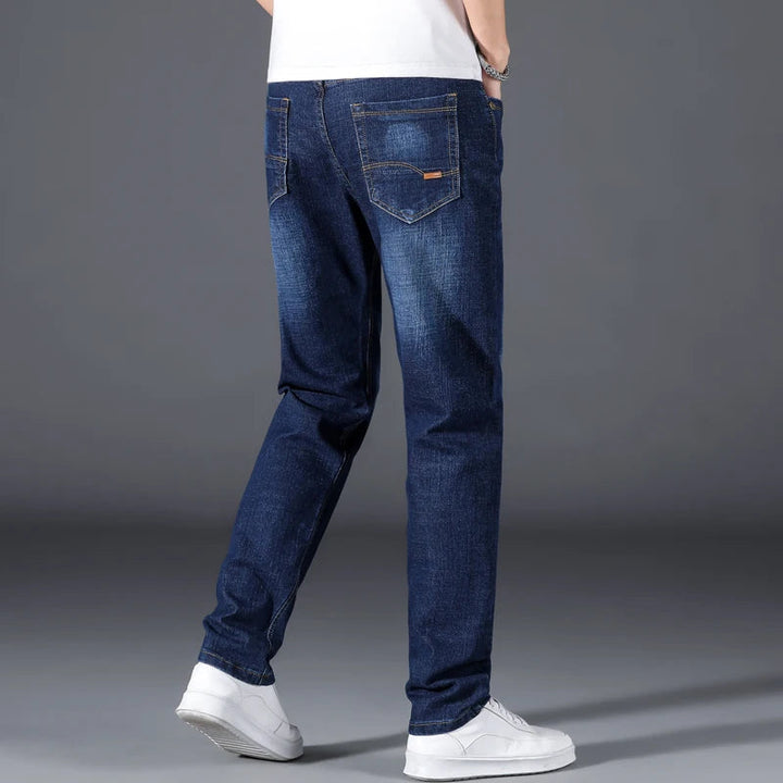 Durable men's straight leg jeans in classic blue, offering relaxed comfort & timeless style for everyday wear.